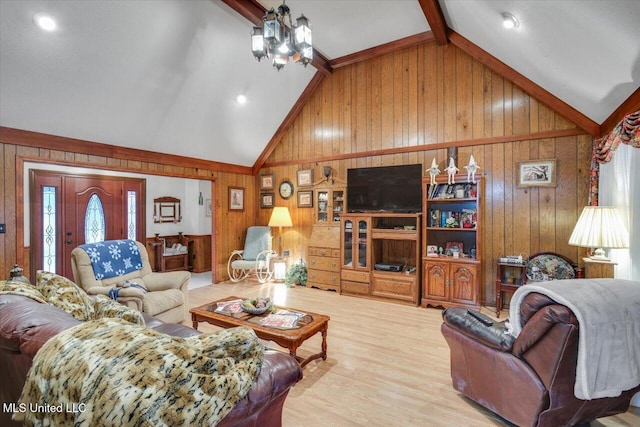 living room with a chandelier, hardwood / wood-style floors, vaulted ceiling with beams, and wooden walls