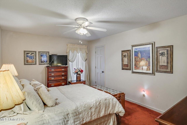 carpeted bedroom featuring a textured ceiling and ceiling fan