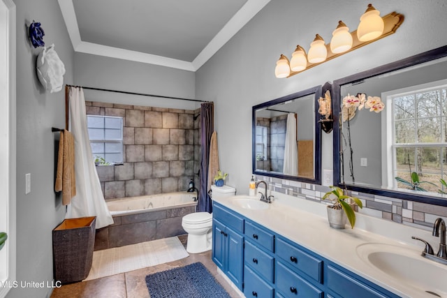 full bath with double vanity, shower / tub combo, toilet, and a sink