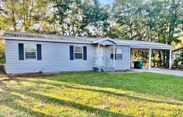 ranch-style home featuring central air condition unit, a front yard, and a carport