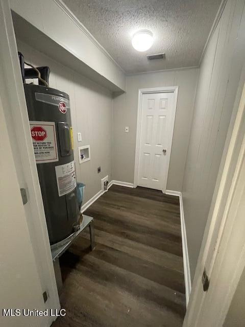 clothes washing area with washer hookup, a textured ceiling, electric water heater, electric dryer hookup, and dark hardwood / wood-style floors