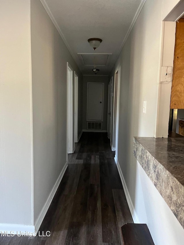 hall with dark hardwood / wood-style floors and crown molding