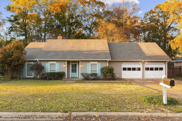 single story home featuring a front yard and a garage