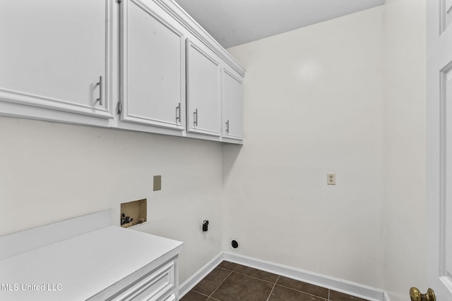 laundry room featuring cabinets, dark tile patterned floors, and hookup for a washing machine