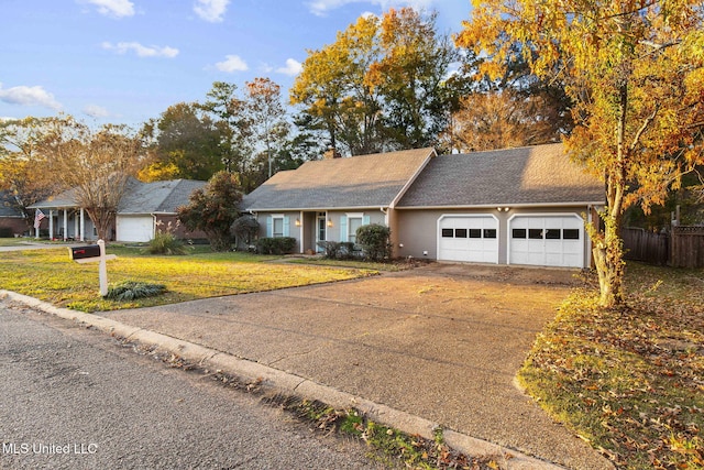 ranch-style house with a garage and a front lawn