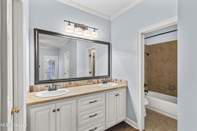 full bathroom featuring tile patterned floors, ornamental molding, vanity, toilet, and tiled shower / bath