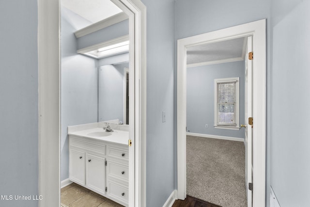 bathroom with vanity and ornamental molding