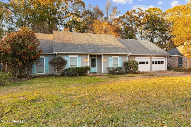 ranch-style home featuring a garage and a front lawn