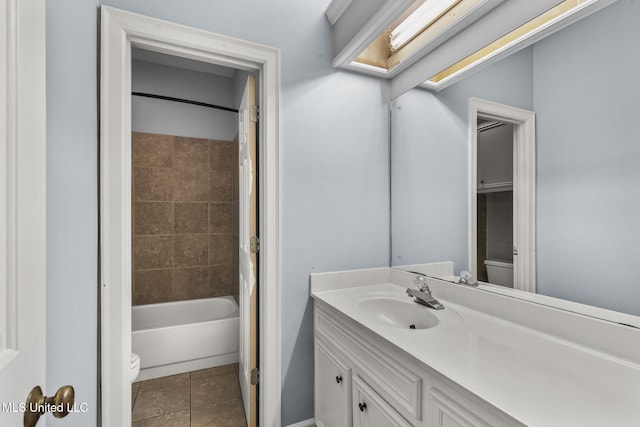 full bathroom with tile patterned flooring, vanity, toilet, and tiled shower / bath