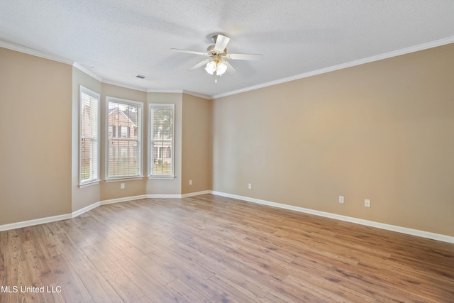 empty room with a textured ceiling, ceiling fan, ornamental molding, and light hardwood / wood-style flooring