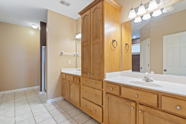 bathroom with tile patterned floors and vanity