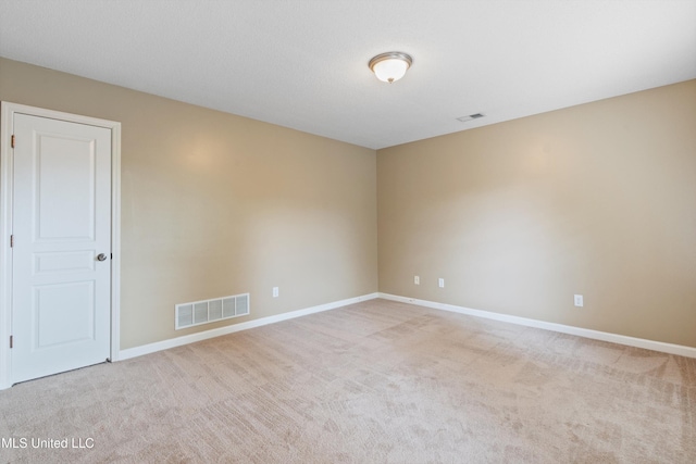 empty room with light colored carpet