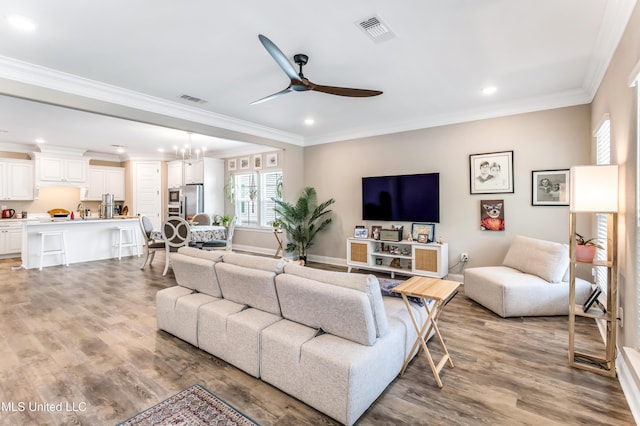 127 Grande View Dr, Biloxi, MS 39531 - living room with ceiling fan with notable chandelier, visible vents, and light wood-type flooring