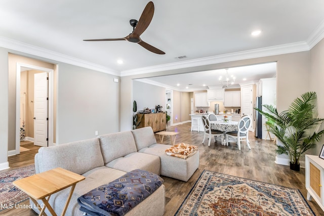127 Grande View Dr, Biloxi, MS 39531 - living room featuring wood finished floors, baseboards, ceiling fan with notable chandelier, visible vents, and ornamental molding
