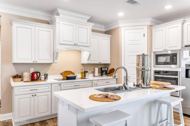 127 Grande View Dr, Biloxi, MS 39531 - kitchen with oven, black electric stovetop, a sink, built in microwave, and visible vents
