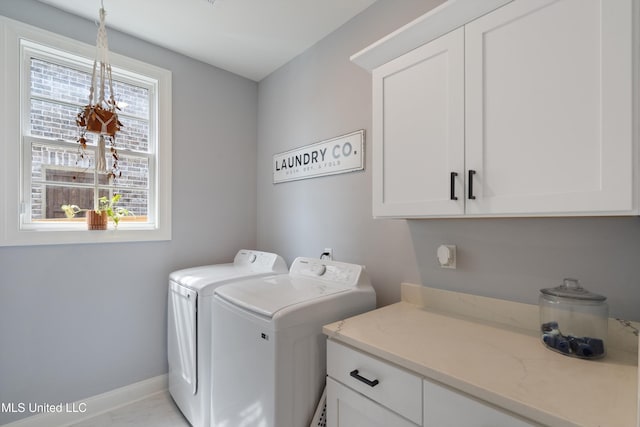 washroom featuring cabinets and washing machine and clothes dryer