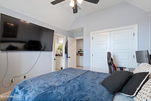 bedroom featuring ceiling fan, a closet, connected bathroom, and vaulted ceiling