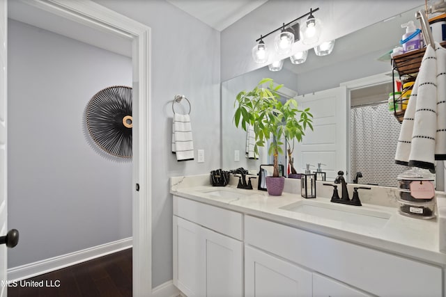 bathroom with hardwood / wood-style floors and vanity