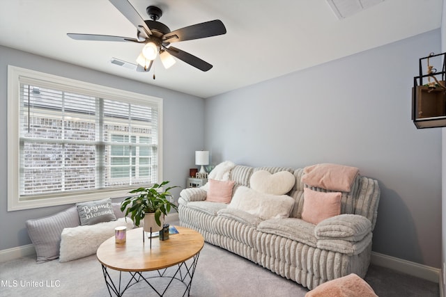 living room featuring ceiling fan and carpet