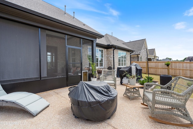 view of patio featuring area for grilling and a sunroom