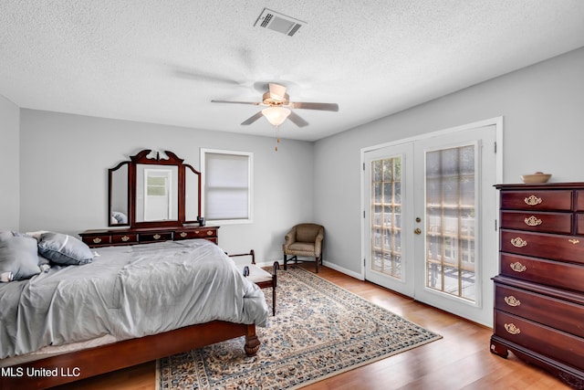 2529 Windward Dr, Gautier, MS 39553 - bedroom featuring access to outside, french doors, wood finished floors, a textured ceiling, and ceiling fan
