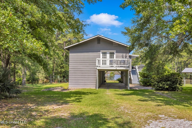 2529 Windward Dr, Gautier, MS 39553 - back of property with stairs, a yard, and a carport