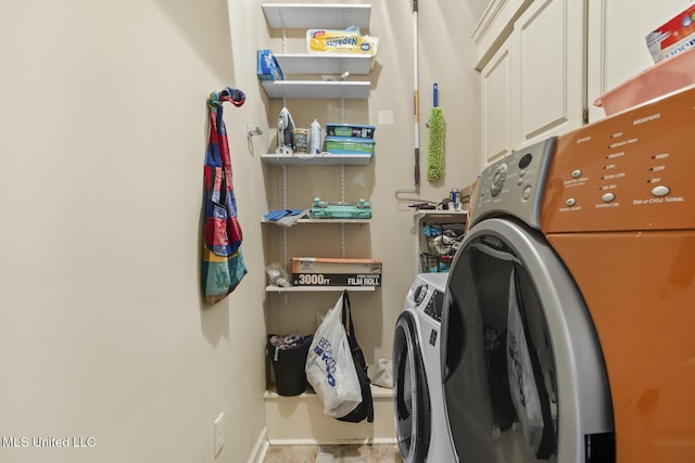 washroom with separate washer and dryer and cabinets