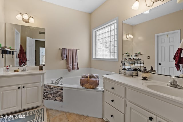 bathroom with vanity, a bath, and tile patterned flooring