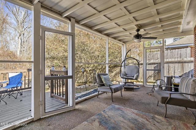 unfurnished sunroom with vaulted ceiling and ceiling fan