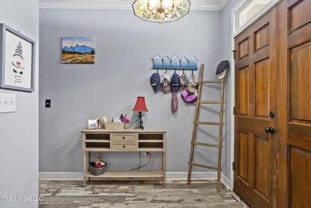 interior space with crown molding, an inviting chandelier, and hardwood / wood-style flooring