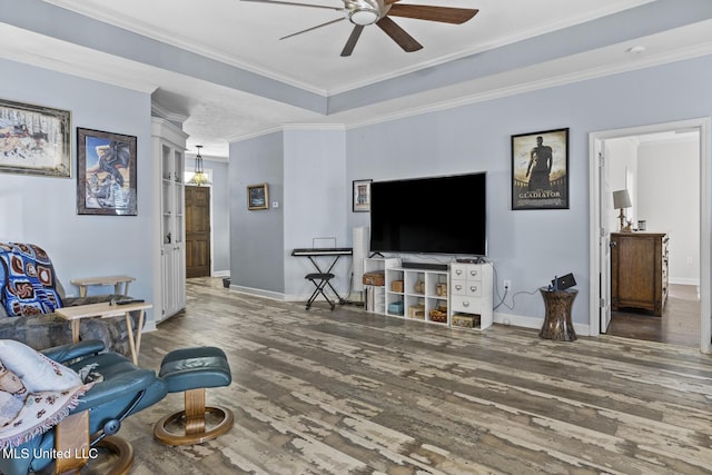 living room with crown molding, ceiling fan, a tray ceiling, and hardwood / wood-style floors