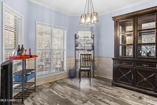 living area featuring an inviting chandelier, ornamental molding, wood-type flooring, and tile walls