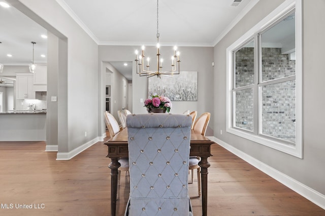 2115 Livingston Way, Hernando, MS 38632 - dining space with wood finished floors, a chandelier, baseboards, crown molding, and recessed lighting