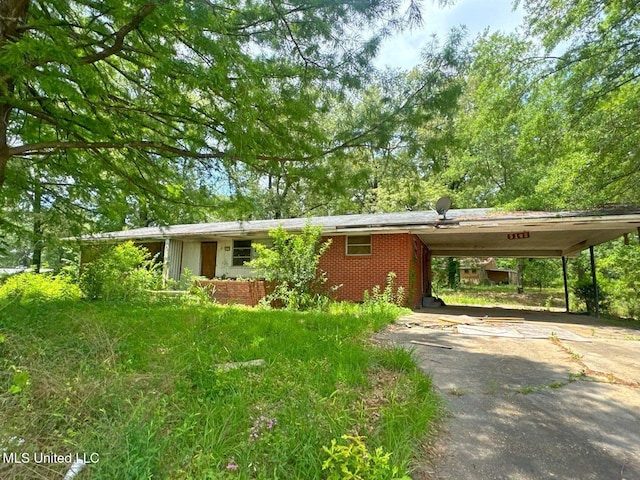 5103 Robinson Rd, Jackson, MS 39204 - view of front of home with driveway, brick siding, and a carport