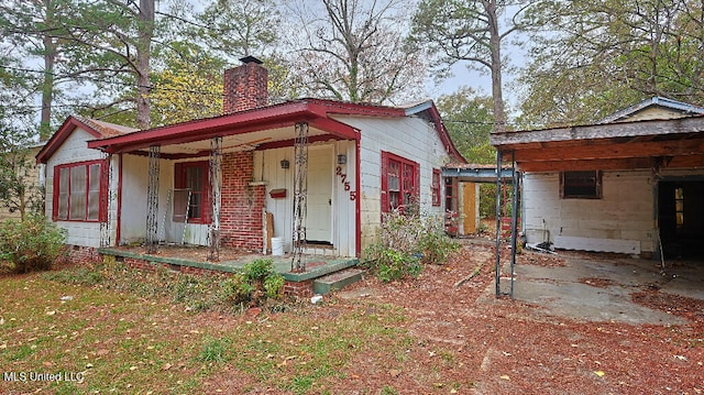 view of outbuilding featuring covered porch and a carport