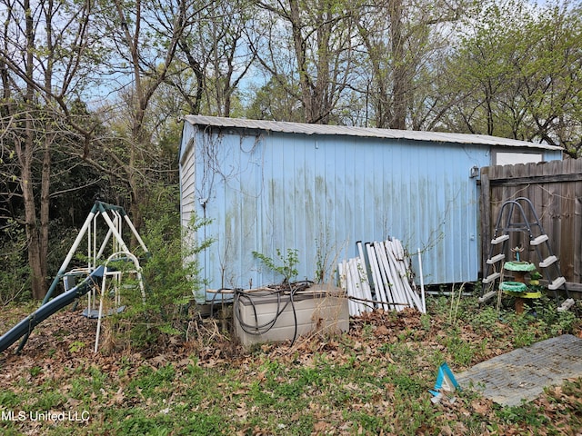 view of shed featuring fence