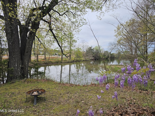 property view of water featuring an outdoor fire pit