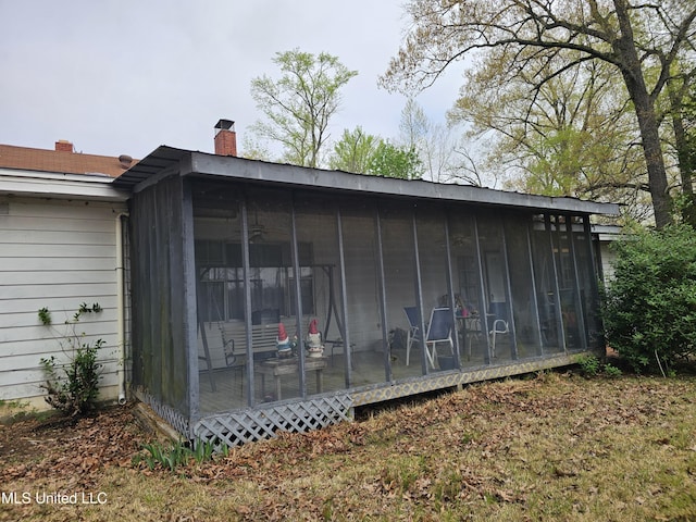 view of outdoor structure featuring a sunroom