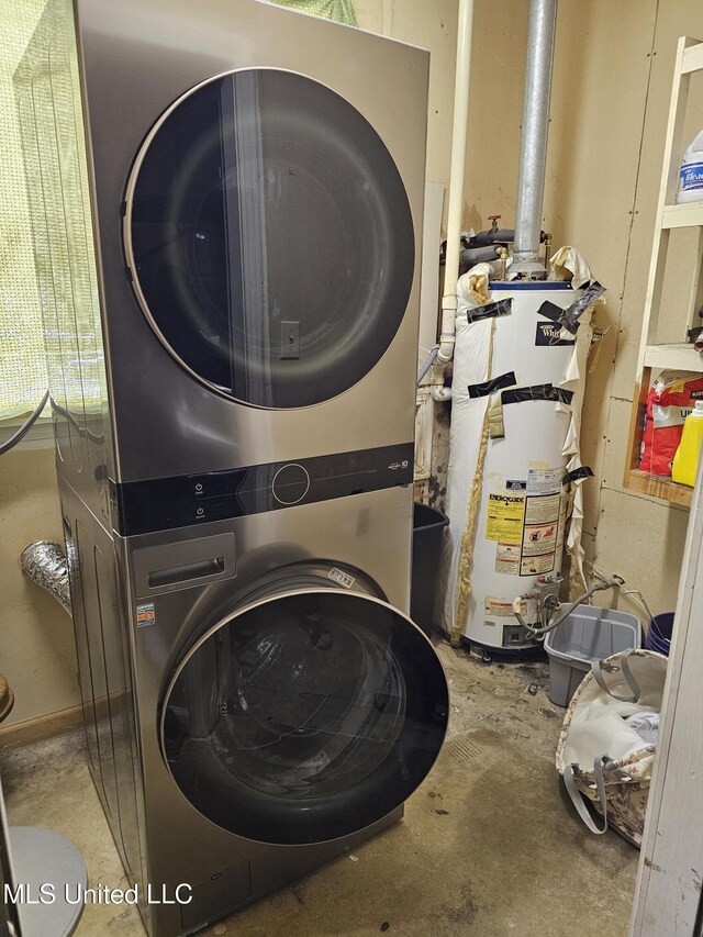 clothes washing area featuring water heater, stacked washer / drying machine, and laundry area