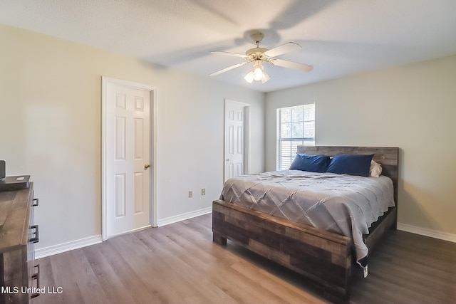 bedroom with ceiling fan and hardwood / wood-style flooring