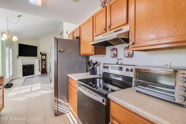 kitchen featuring light tile patterned floors, stainless steel appliances, decorative light fixtures, lofted ceiling, and a chandelier