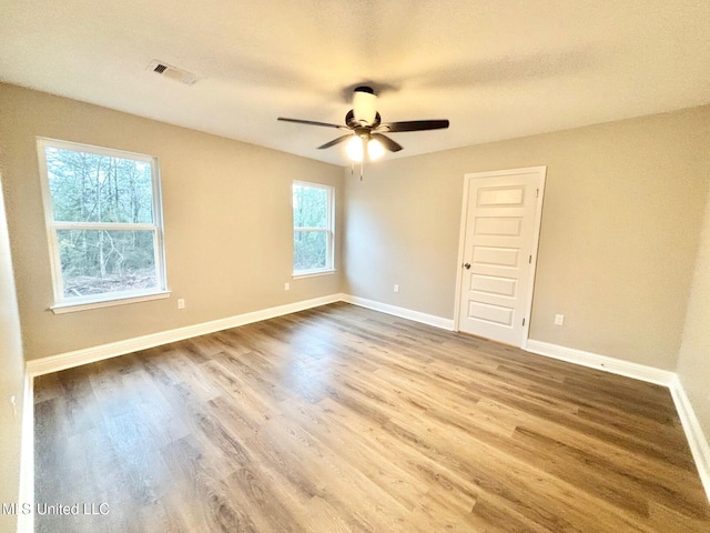 unfurnished room featuring hardwood / wood-style flooring, ceiling fan, and a textured ceiling