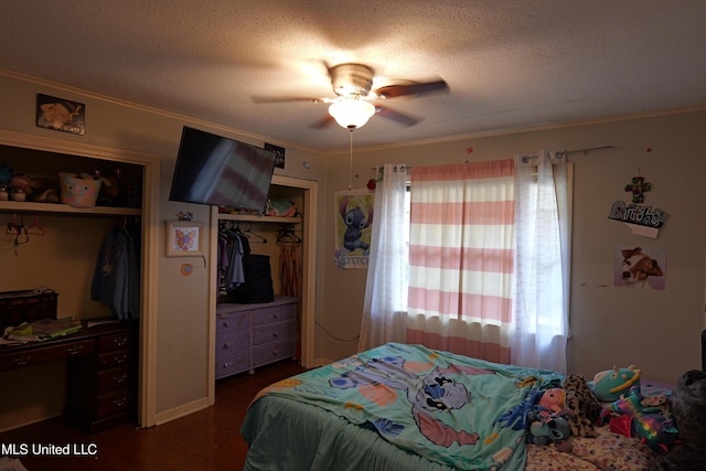 bedroom featuring ornamental molding, a textured ceiling, a ceiling fan, and wood finished floors