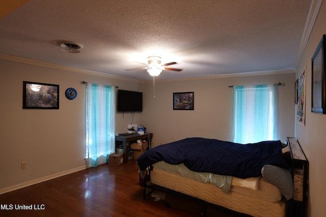 bedroom with crown molding, baseboards, wood finished floors, and multiple windows