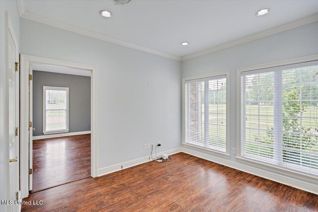 spare room with baseboards, recessed lighting, ornamental molding, and dark wood-style flooring