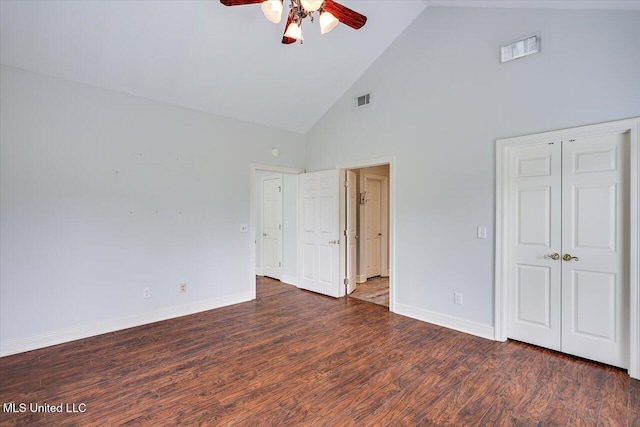 unfurnished bedroom with baseboards, wood finished floors, visible vents, and high vaulted ceiling