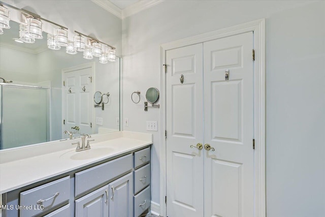 bathroom with vanity, ornamental molding, and a stall shower