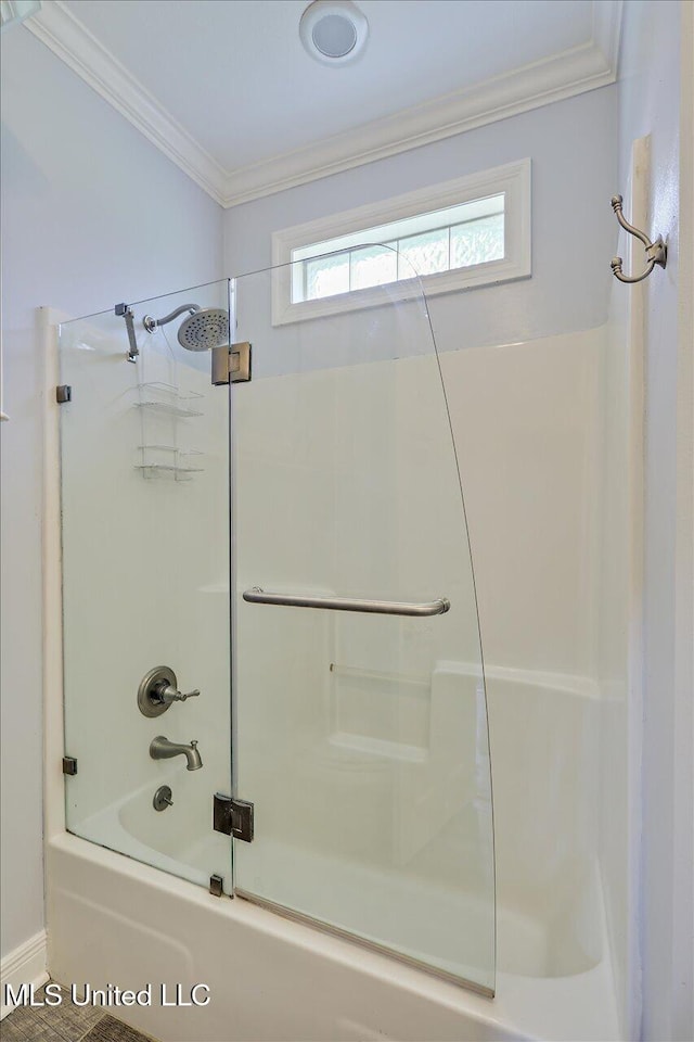 bathroom featuring enclosed tub / shower combo and crown molding