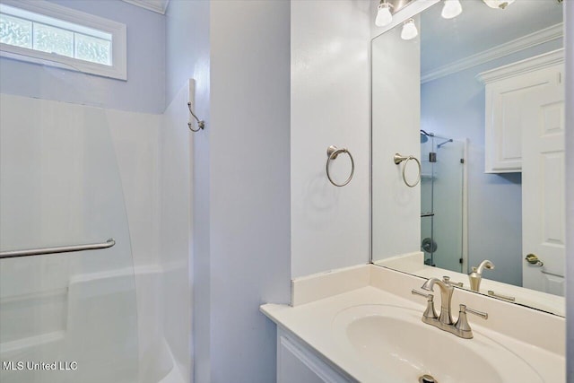 bathroom featuring walk in shower, vanity, and ornamental molding