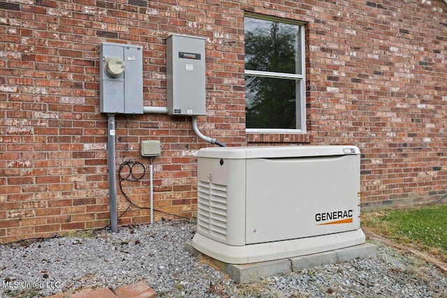 details featuring electric meter, brick siding, and a power unit
